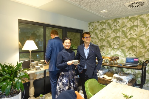 Cllr Bridget Smith drinking a cup of tea with Inspired Villages Chief Finance Officer, Tom Ford