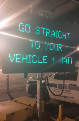 A sign that says go straight to your vehicle and wait