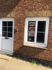 A picture of a rainbow in a window